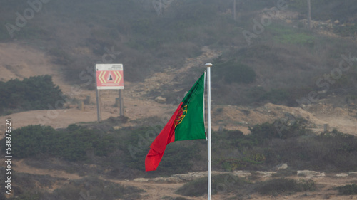 Portuguese flag blowing in the wind, Ribeira d'Ilhas, Portugal