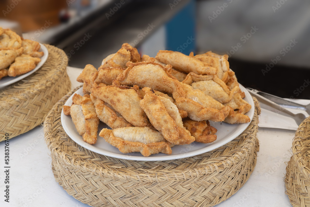 Traditional Spanish snacks or empanadas at local food market in
