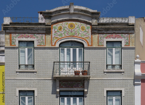 Streets of Lisbon. Traditional Revival facade decorated with colorful flower tiles. Portugal. 