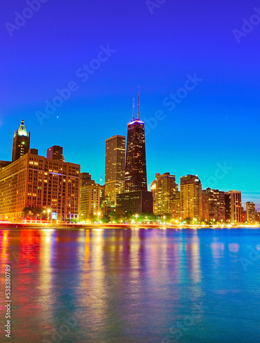 View of Chicago skyline from the shore of Lake Michigan at night.