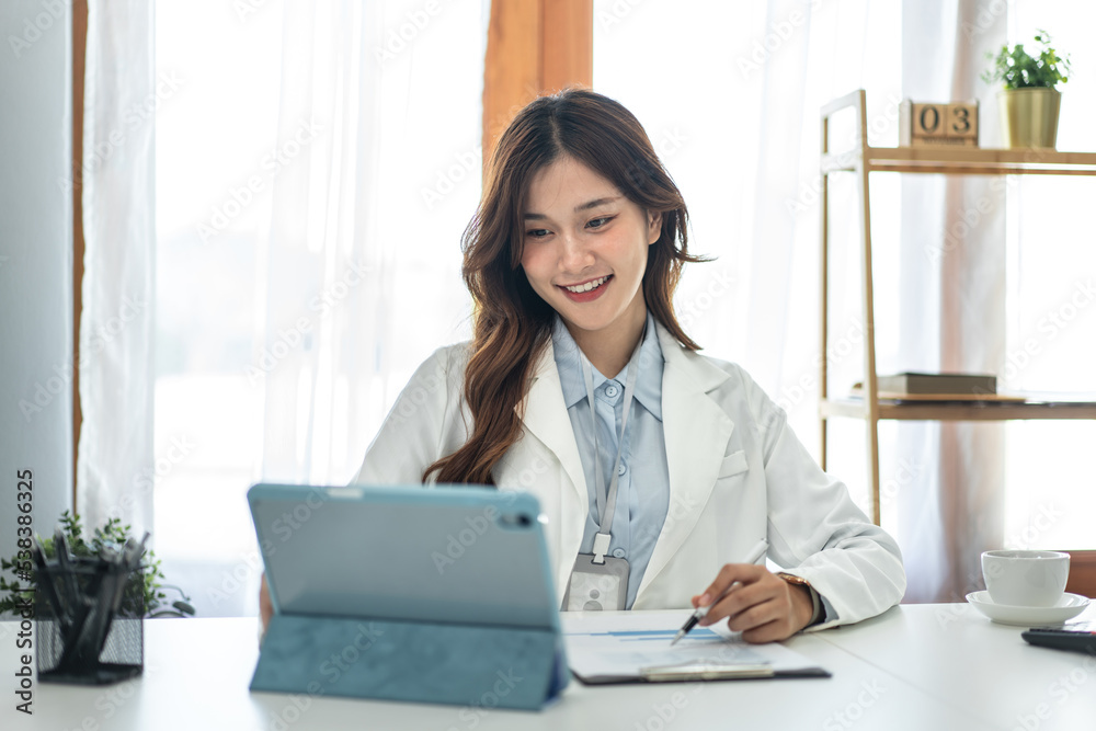 Businesswoman is reading marketing plan report on tablet to taking notes in document and analysis Businesswoman is reading marketing plan report on tablet to taking notes in document and analysis