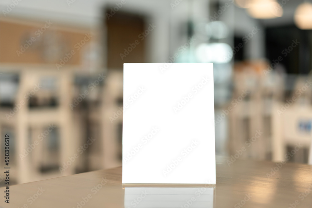 Menu frame with white blank screen on wooden table in restaurant or cafe on bokeh background Menu frame with white blank screen on wooden table in restaurant or cafe on bokeh background