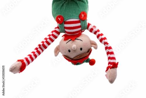 Elf on a Shelf hanging upside down isolated on white background