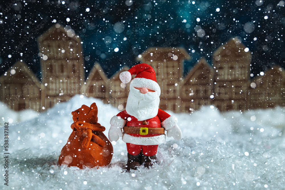 Santa Claus at night in a toy snowy town. Santa Claus at night in a toy snowy town.