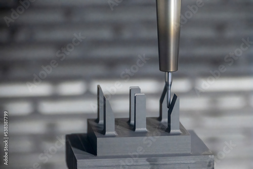 The CNC milling machine cutting the graphite electrode parts with solid ball end mill.