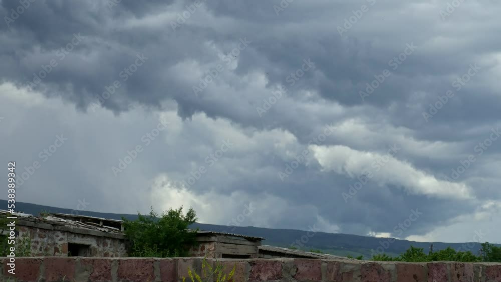 Time-lapse of fast-moving stormy clouds on a rainy day in a rural area Time-lapse of fast-moving stormy clouds on a rainy day in a rural area