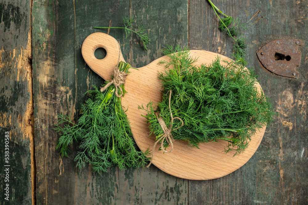 Fresh dill close up on wooden box on dark background, preparation for freezing serving size organic healthy ething natural product portion. place for text