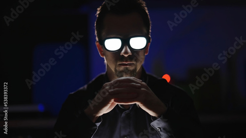 Photos Live action anime villain with glowing glasses think while look into camera