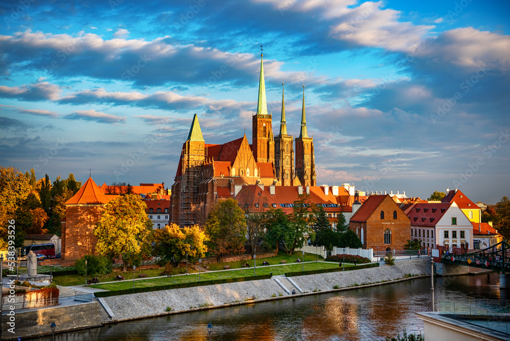 Evening view on Wroclaw Old Town. Island and Cathedral of St John with bridge through river Odra. Wroclaw, Poland. Evening view on Wroclaw Old Town. Island and Cathedral of St John with bridge through river Odra. Wroclaw, Poland.