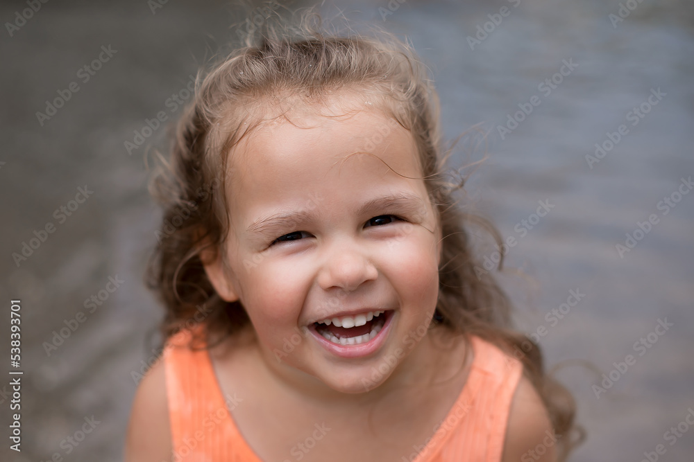 little girl smiles. happy face of a child. girl is enjoying a walk little girl smiles. happy face of a child. girl is enjoying a walk
