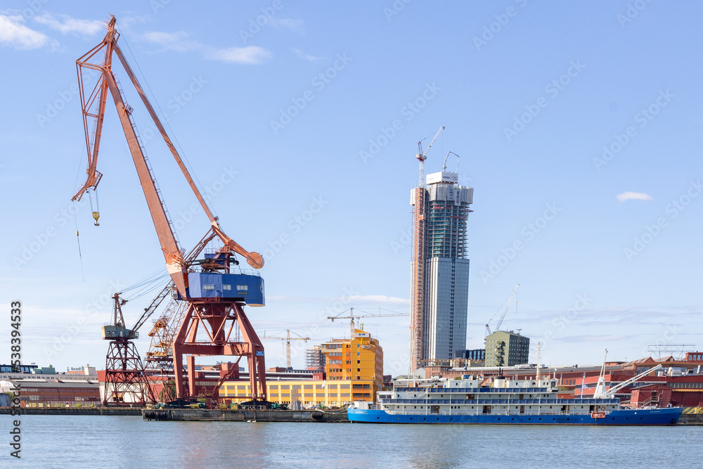 Cranes in Gothenburg harbor with traffic and activity,Sweden,Europe