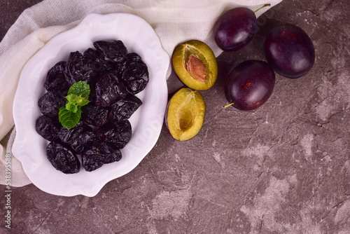 A plate with prunes.Dried plums.Flet ley.Copy space.
 photo