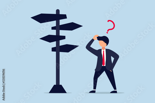 Business decision making, career path, work direction or choose the right way to success concept, confusing businessman looking at multiple road sign with question mark and thinking which way to go