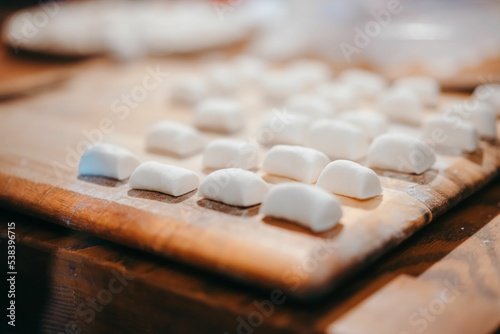 Closeup of fluffy marshmallows in rows on a wooden board