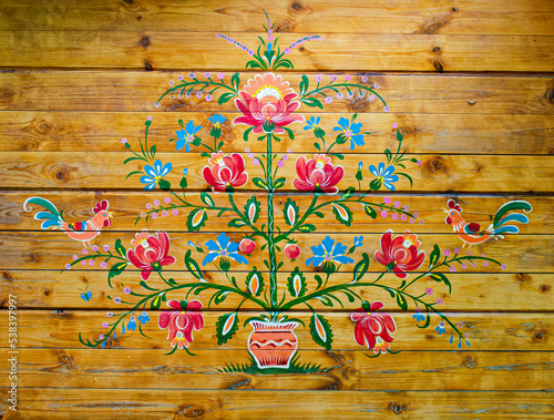 Petrykivka painting on a wooden wall