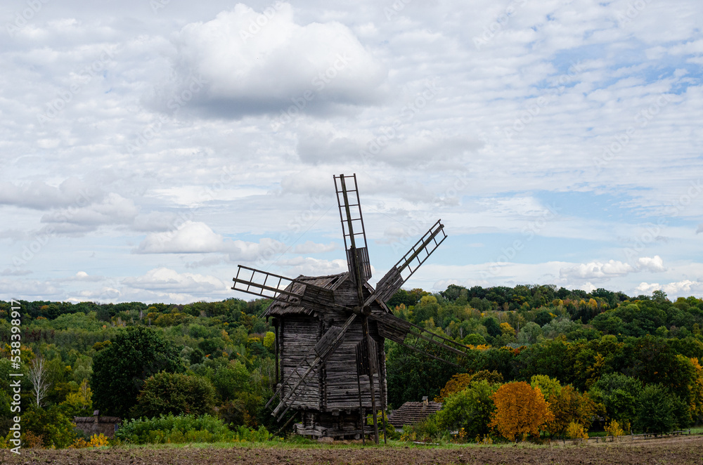 Summer landscape with an old wooden mill Summer landscape with an old wooden mill