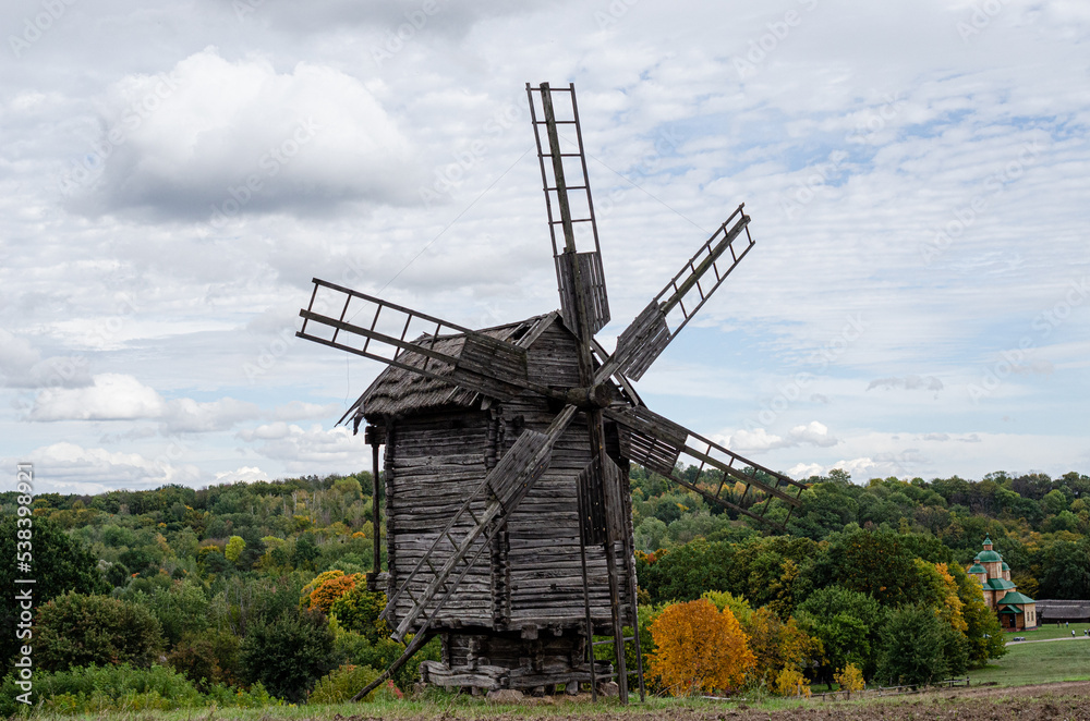 Summer landscape with an old wooden mill