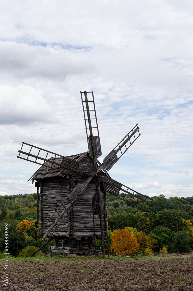Summer landscape with an old wooden mill