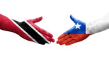 Handshake between Chile and Trinidad Tobago flags painted on hands, isolated transparent image.