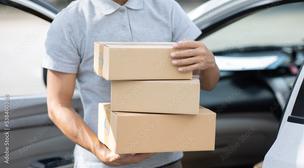 Asian male delivery service delivery service Deliver parcels to the hand outside the location Asian male delivery service delivery service Deliver parcels to the hand outside the location