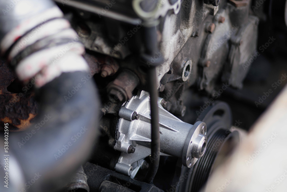 concept of replacing the water pump of the car engine cooling system, a new aluminum car spare part pump. concept of replacing the water pump of the car engine cooling system, a new aluminum car spare part pump.