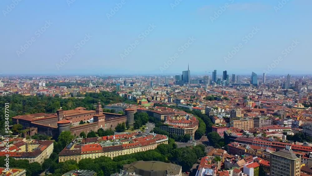 Aerial view early in the morning of Castello Sforzesco, green trees in sempione park. Modern architecture and roofs. View of the bell tower. The fountain. Vision. Ecology. Milan. Italy, August 2022