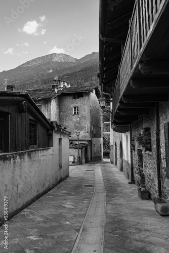 Photos Black and white Photo of a Road without People with Rock Dwellings in Morgex in