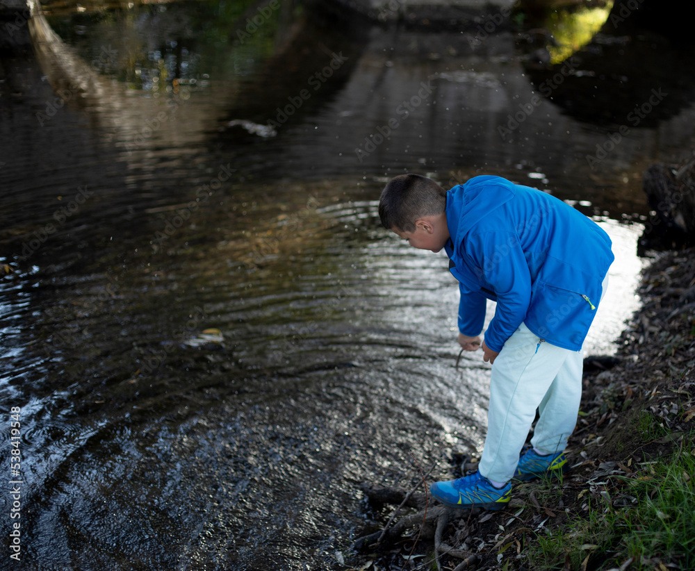 boy playing in the river boy playing in the river