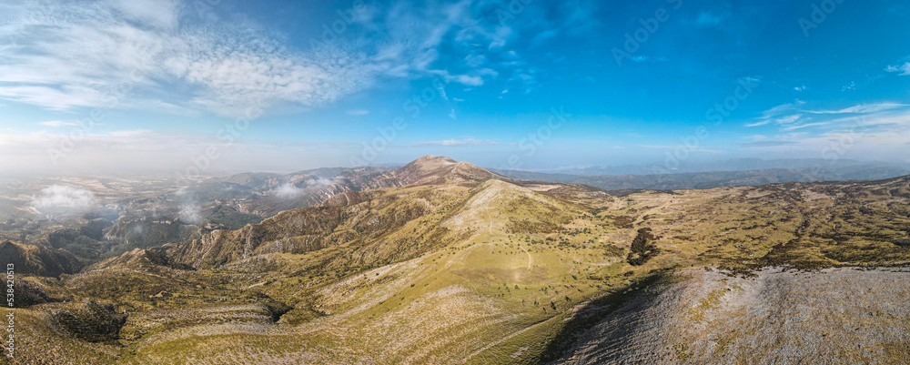 Photograph taken from a drone of the landscape and the mountains of Sierra de Guara, in it we can see the Pico de Guara from Tozal de Cubilas, covered in clouds. Huesca, Aragon, Spain.