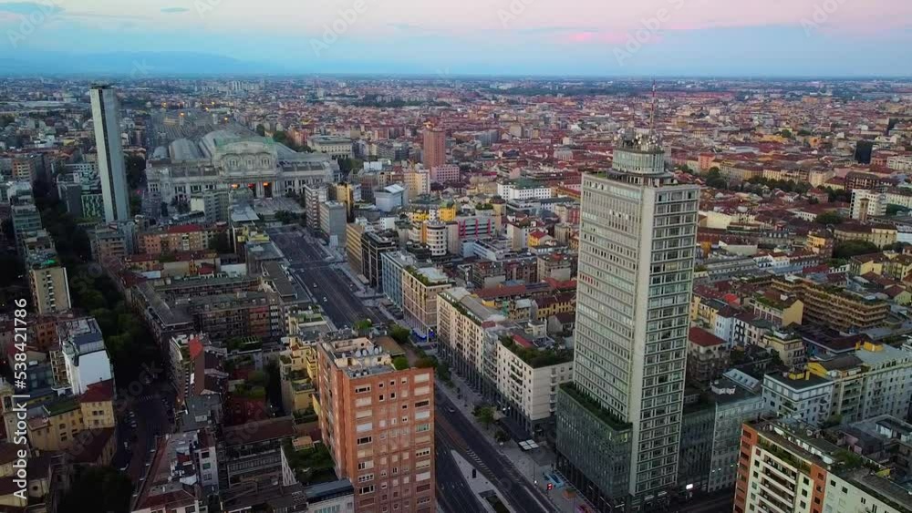 Aerial view of the station. Trains arrive at the station. An old wide arched structure of metal and glass above the station pillars. Tourism. Skyline with tall buildings. Italy, Milan, 03.2023 Aerial view of the station. Trains arrive at the station. An old wide arched structure of metal and glass above the station pillars. Tourism. Skyline with tall buildings. Italy, Milan, 03.2023