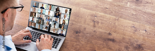 Businessperson Videoconferencing On Laptop photo