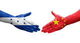 Handshake between China and Honduras flags painted on hands, isolated transparent image.