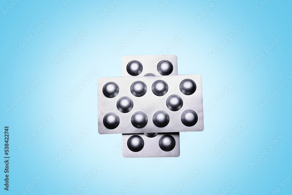 Set of medical tablets and pills in pharmaceutical blister pack on blue Set of medical tablets and pills in pharmaceutical blister pack on blue