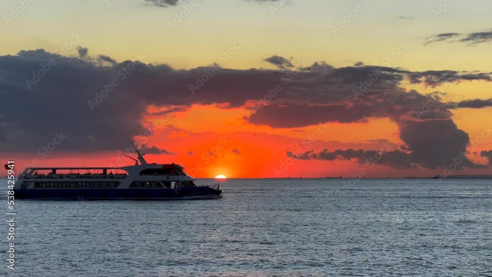 Silhouette of an in city passenger ship sailing across the stunning sunset over the Marmara Sea. Princes Islands liner motorboat underway at sunset
Silhouette of an in city passenger ship sailing across the stunning sunset over the Marmara Sea. Princes Islands liner motorboat underway at sunset