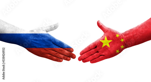 Handshake between China and Russia flags painted on hands, isolated transparent image.
