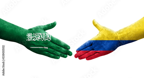 Handshake between Colombia and Saudi Arabia flags painted on hands, isolated transparent image.