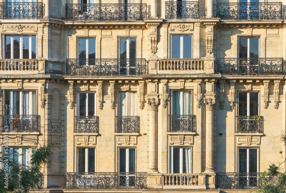Parisian architecture. Facade of historical apartment building. Parisian balconies. Paris, France. Parisian architecture. Facade of historical apartment building. Parisian balconies. Paris, France.