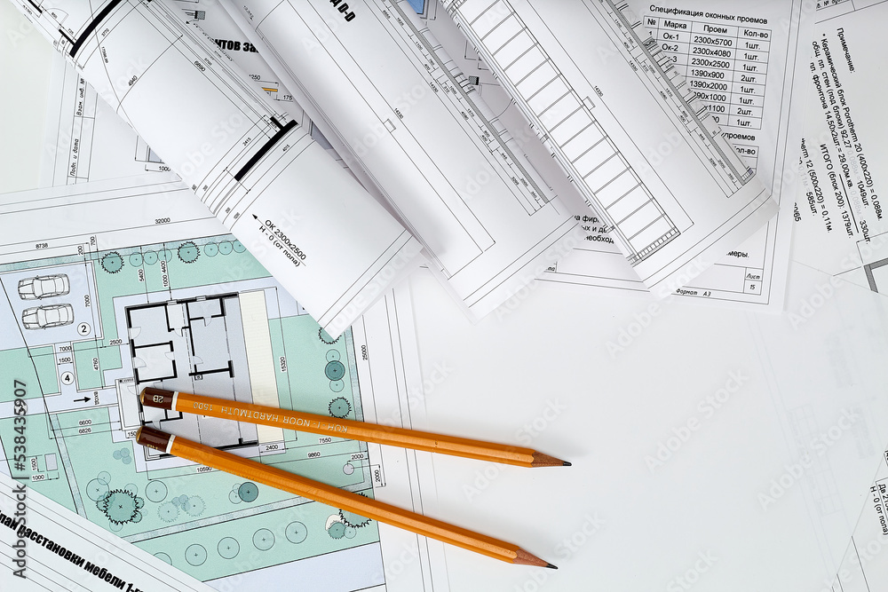 Working tools and drawings of the designer on a white background. Construction of houses, drawing, interior design. Working tools and drawings of the designer on a white background. Construction of houses, drawing, interior design.