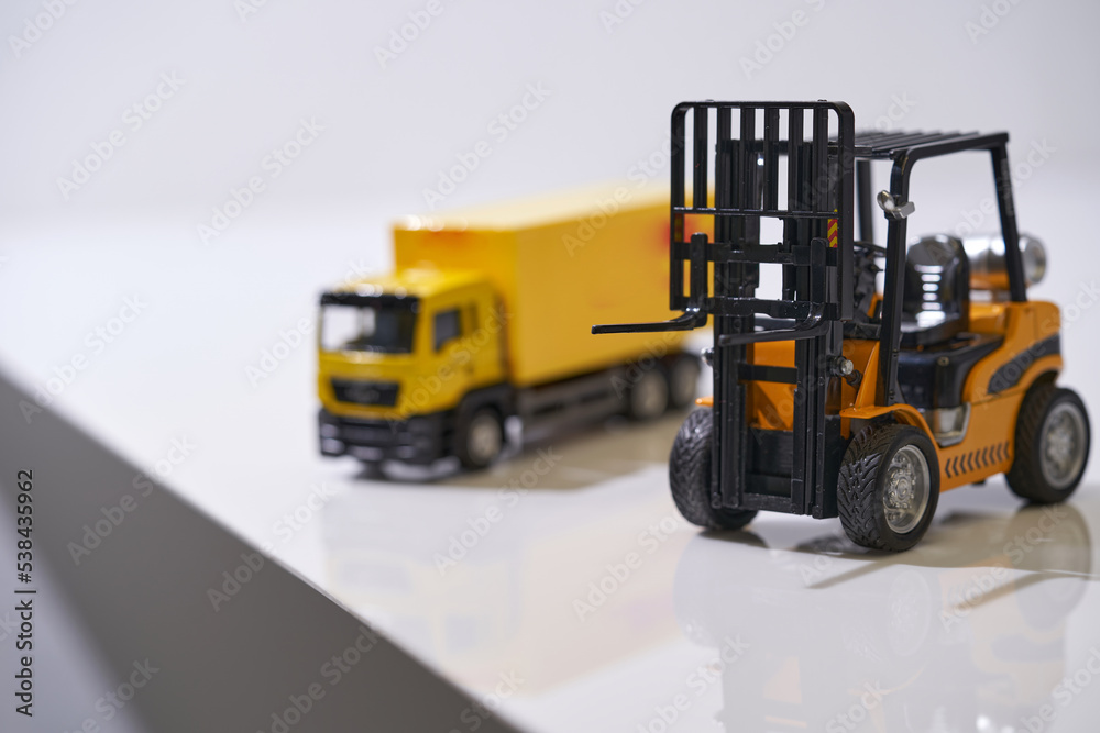 Logistics, and delivery service - Cargo truck and forklift against white background