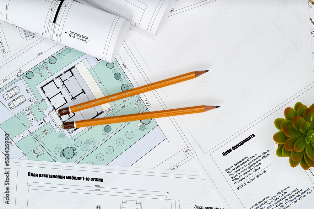 Working tools and drawings of the designer on a white background. Construction of houses, drawing, interior design. Working tools and drawings of the designer on a white background. Construction of houses, drawing, interior design.