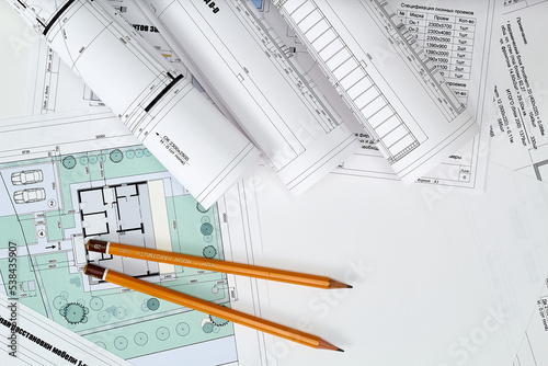 Working tools and drawings of the designer on a white background. Construction of houses, drawing, interior design.