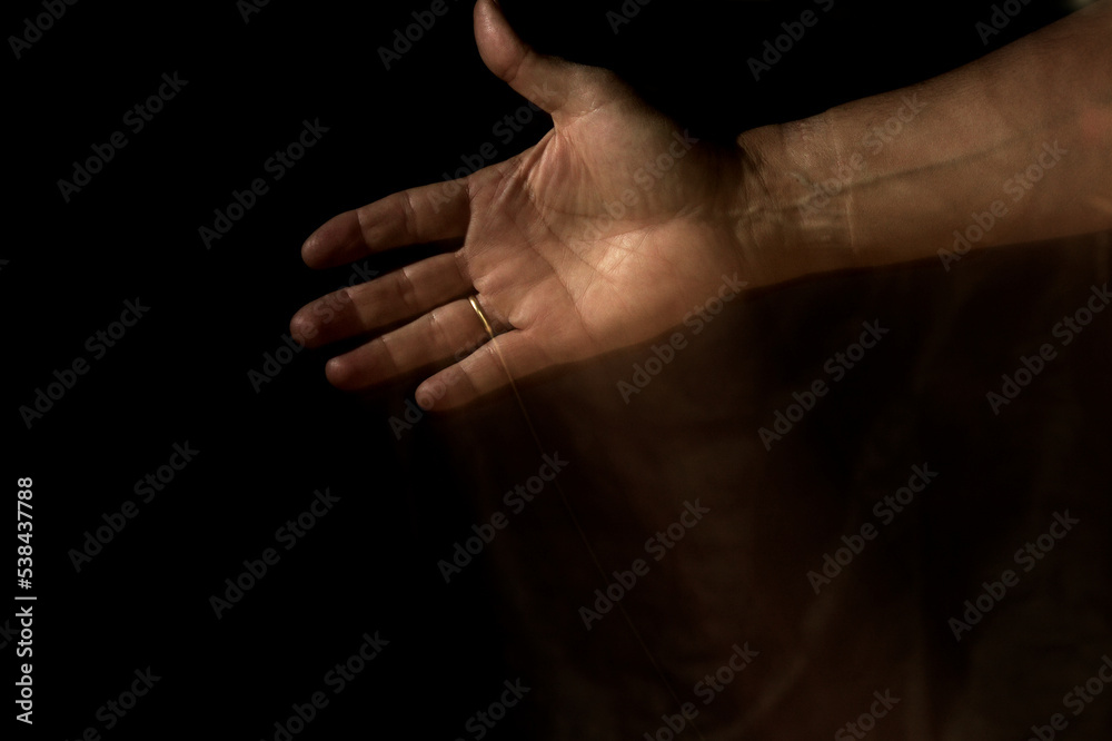 open hand palm moving up. Black background and motion trail. open hand palm moving up. Black background and motion trail.