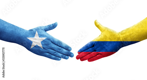 Handshake between Colombia and Somalia flags painted on hands, isolated transparent image.