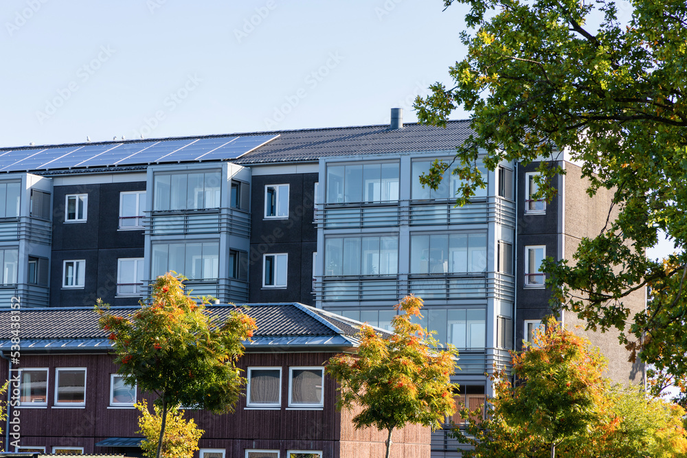 Residential building with new roof and solar panels. Real estate investment. Expensive housing. Residential building with new roof and solar panels. Real estate investment. Expensive housing.