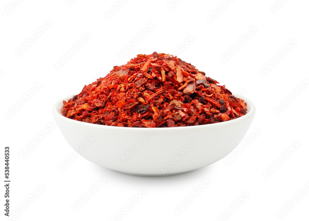 Organic sweet paprika flakes in ceramic bowl isolated on white background Organic sweet paprika flakes in ceramic bowl isolated on white background