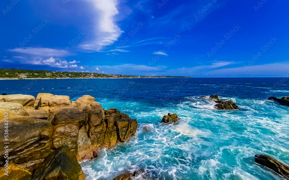 Beautiful surfer waves rocks cliffs at beach Puerto Escondido Mexico. Beautiful surfer waves rocks cliffs at beach Puerto Escondido Mexico.