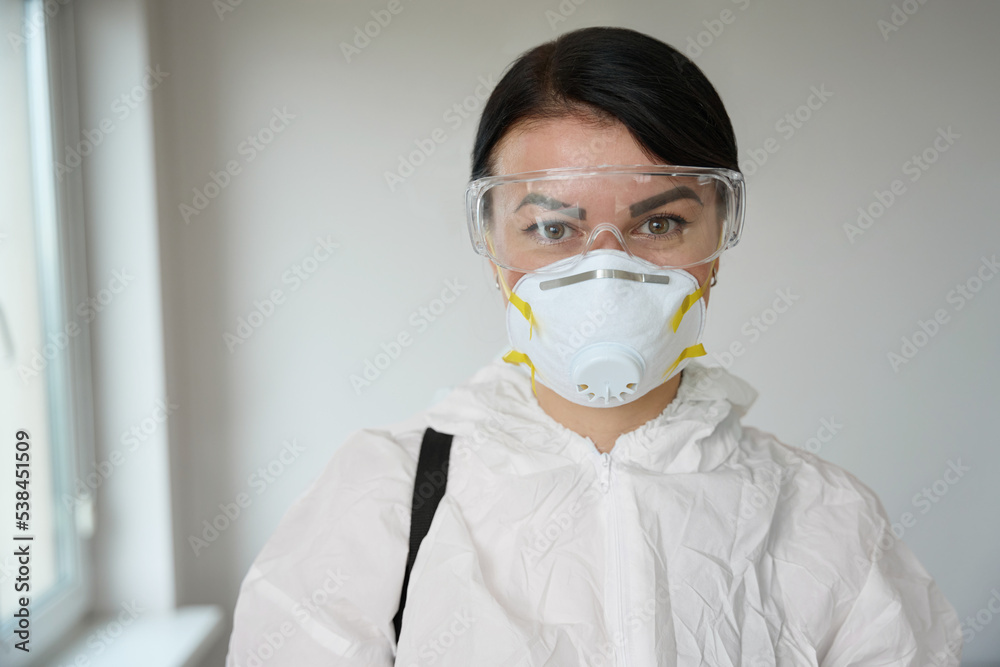 Close-up photo of woman in protective clothes and glasses Close-up photo of woman in protective clothes and glasses