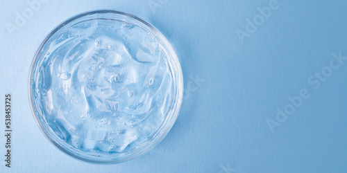 Top view of cosmetics gel with bubbly structure in the petri dish.Cosmetics banner with copy space. © Bidzilya