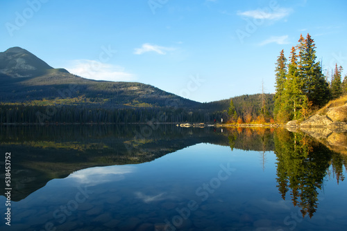 Landscape of reflection of beautiful forest in the lake waters in fall.