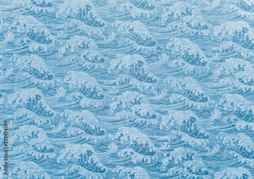 Fotografering Closeup detailed photograph of traditional Japanese wrapping cotton cloth named furoshiki depicting a pattern of a great wave in blue sea evocating the popular cresting wave of ukiyo-e artist hokusai
